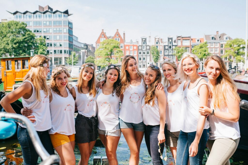 Gruppo di donne sorridenti abbracciate in città, esempio di creare una rete sociale di supporto efficace attraverso relazioni autentiche e presenza reciproca.